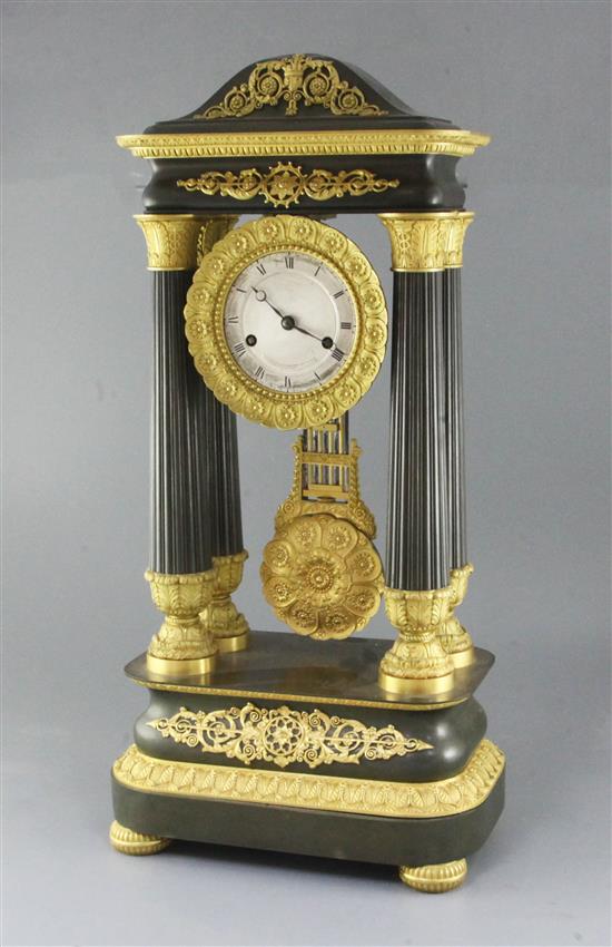A mid 19th century French bronze and ormolu portico clock, height 25in.